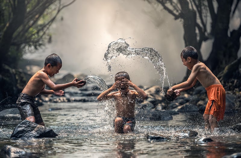 Children playing with water in the summer